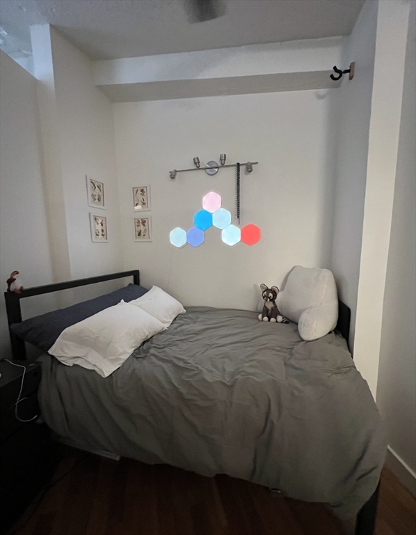 12 Stoneholm Street, Unit 322 Boston, MA 02115 - Photo 3 of 33 a bedroom with a bed and a cabinets