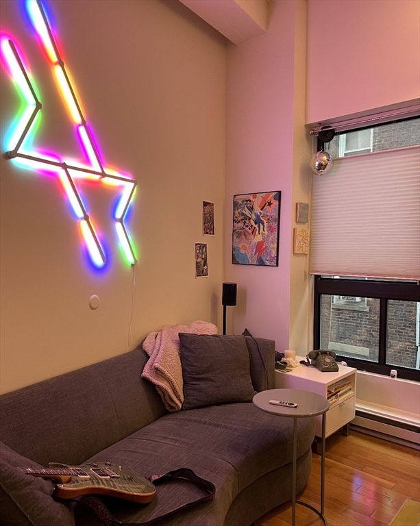 12 Stoneholm Street, Unit 322 Boston, MA 02115 - Photo 4 of 33 a living room with furniture and a air conditioner vent