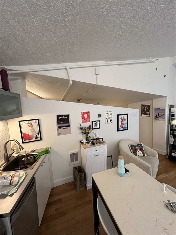 12 Stoneholm Street, Unit 322 Boston, MA 02115 - Photo 10 of 33 a kitchen with stainless steel appliances a stove a chimney a sink and cabinets