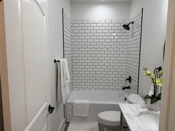 a bathroom with a toilet and shower