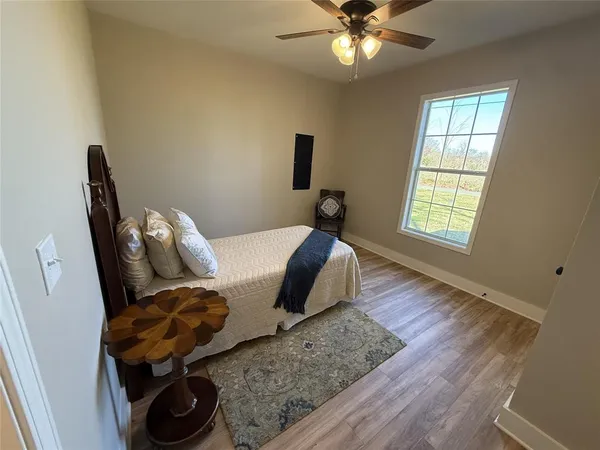 a bed room with a bed window and a chandelier