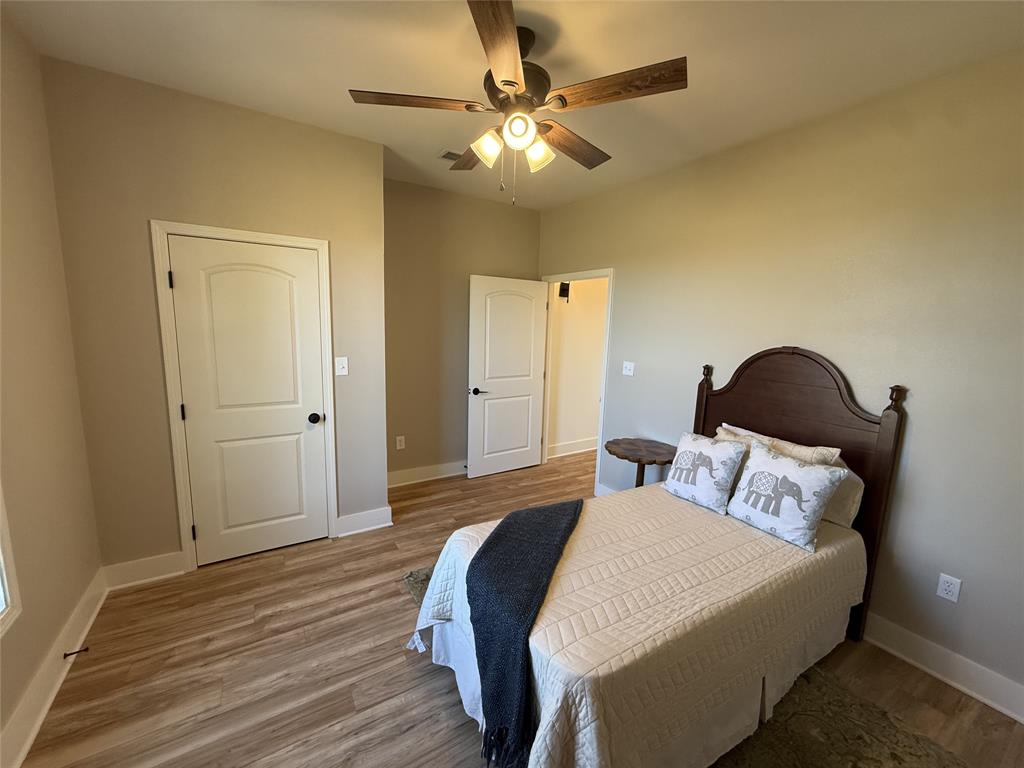 123 Church Street Belcher, LA 71004 - Photo 17 of 30 a bedroom with a bed and a chandelier