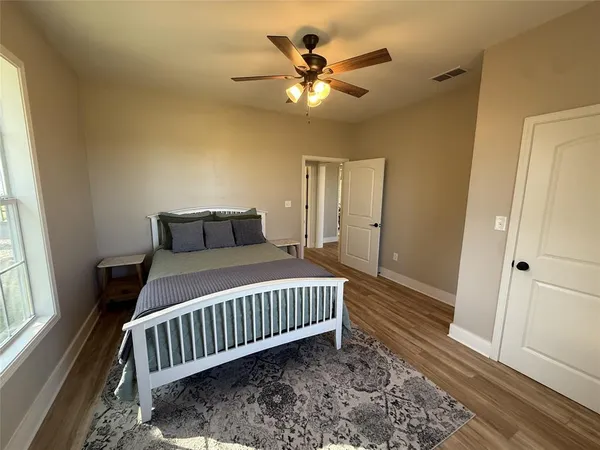 a bedroom with a bed and a window