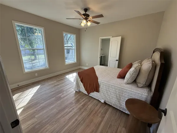 a bedroom with a bed and wooden floor