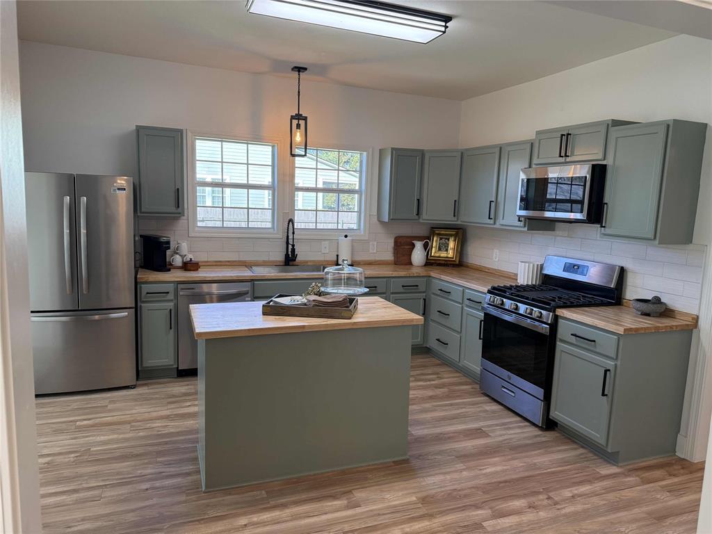 123 Church Street Belcher, LA 71004 - Photo 9 of 30 a kitchen with kitchen island stainless steel appliances a sink stove refrigerator and a window