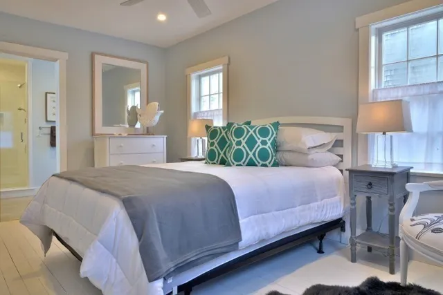 a bedroom with a bed and a painting on the wall