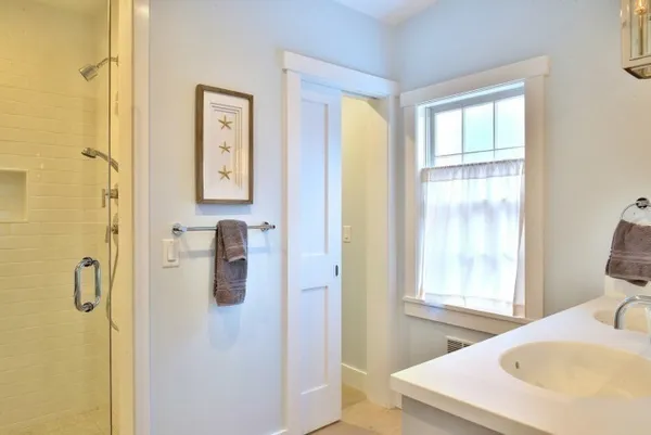 a en suite bathroom with a sink double vanity and a mirror