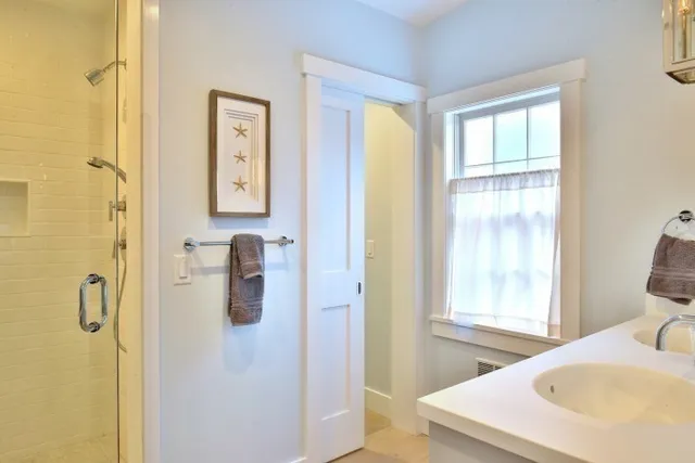 a en suite bathroom with a sink double vanity and a mirror