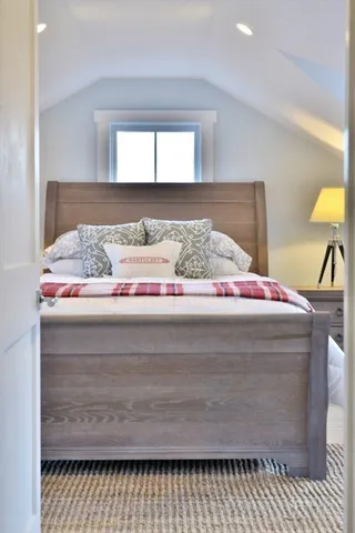 a bedroom with bed and window