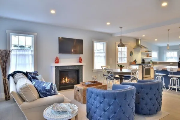 a living room with furniture a fireplace and a flat screen tv