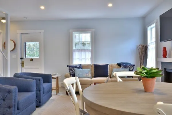 a large kitchen with kitchen island a table and chairs in it