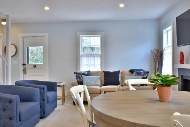 a large kitchen with kitchen island a table and chairs in it