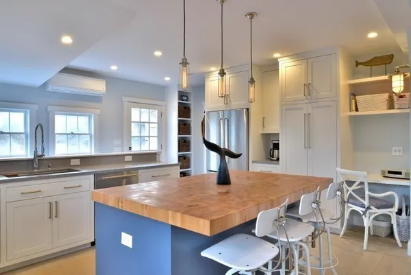 a kitchen with a stove a sink and a wooden floor