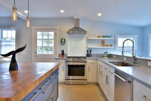 a large kitchen with kitchen island a sink counter space appliances and a living room view