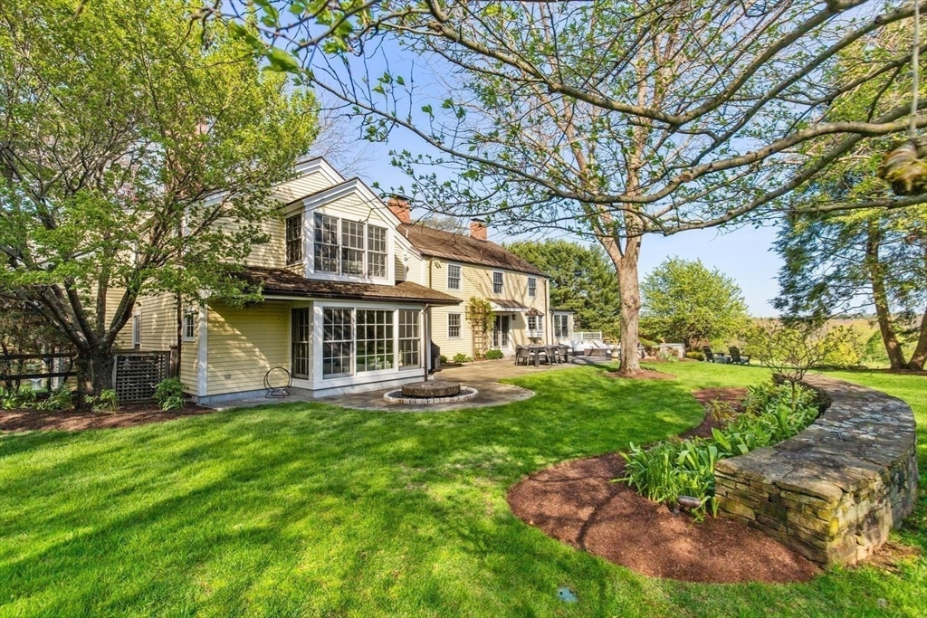 151 Oakland Street Wellesley, MA 02481 - Photo 2 of 42 a front view of a house with a yard and trees