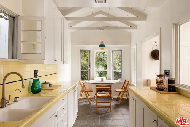 a kitchen with a sink and a large window