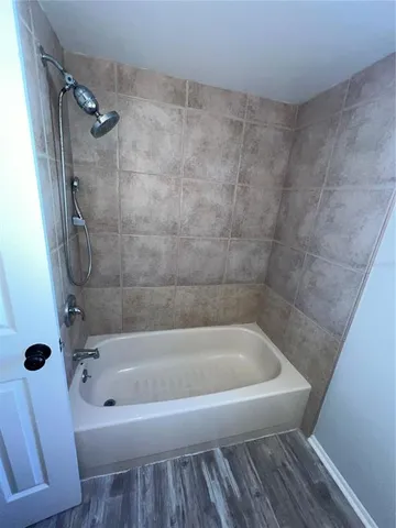 a white bath tub sitting next to a toilet