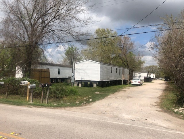 3182 Brownie Campbell Road Houston, TX 77038 - Photo 2 of 7 a view of a street with a building and a street light