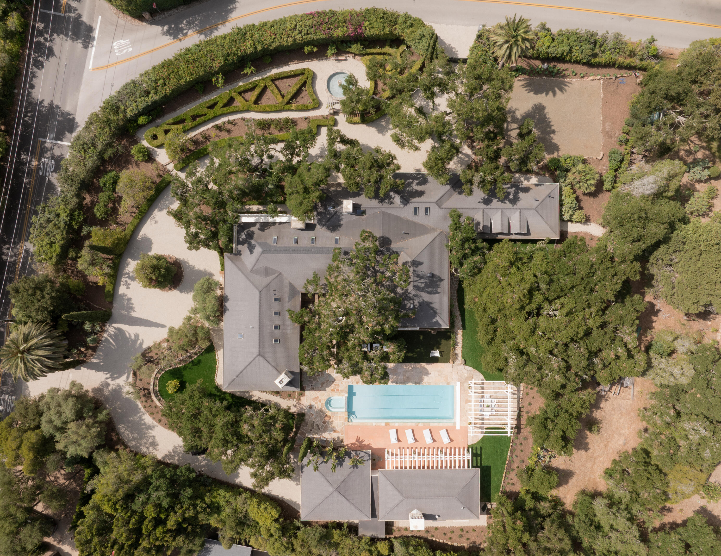 an aerial view of a house with a yard and lake view