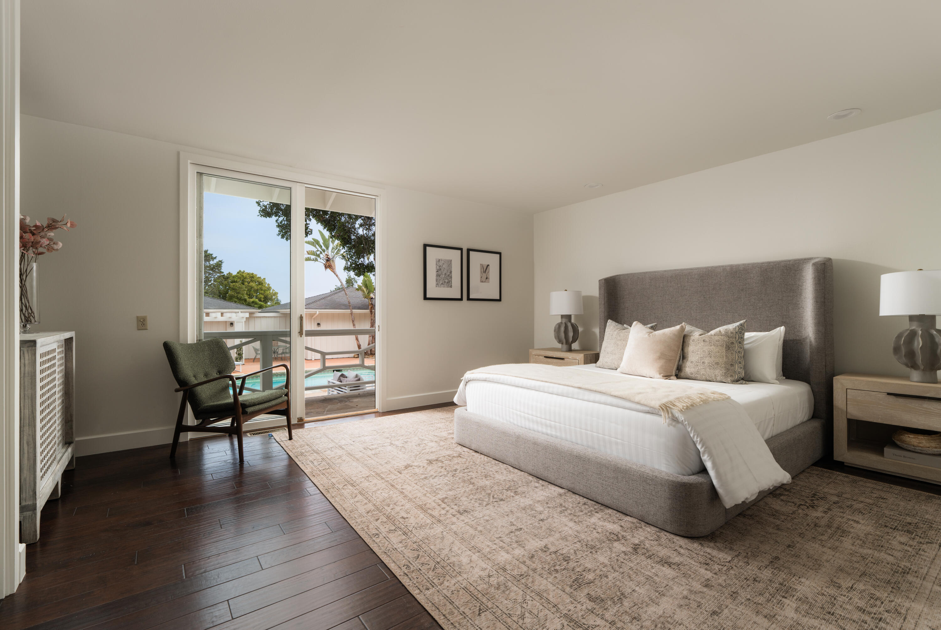 690 San Ysidro Road Montecito, CA 93108 - Photo 21 of 42 a spacious bedroom with a bed a table and chair