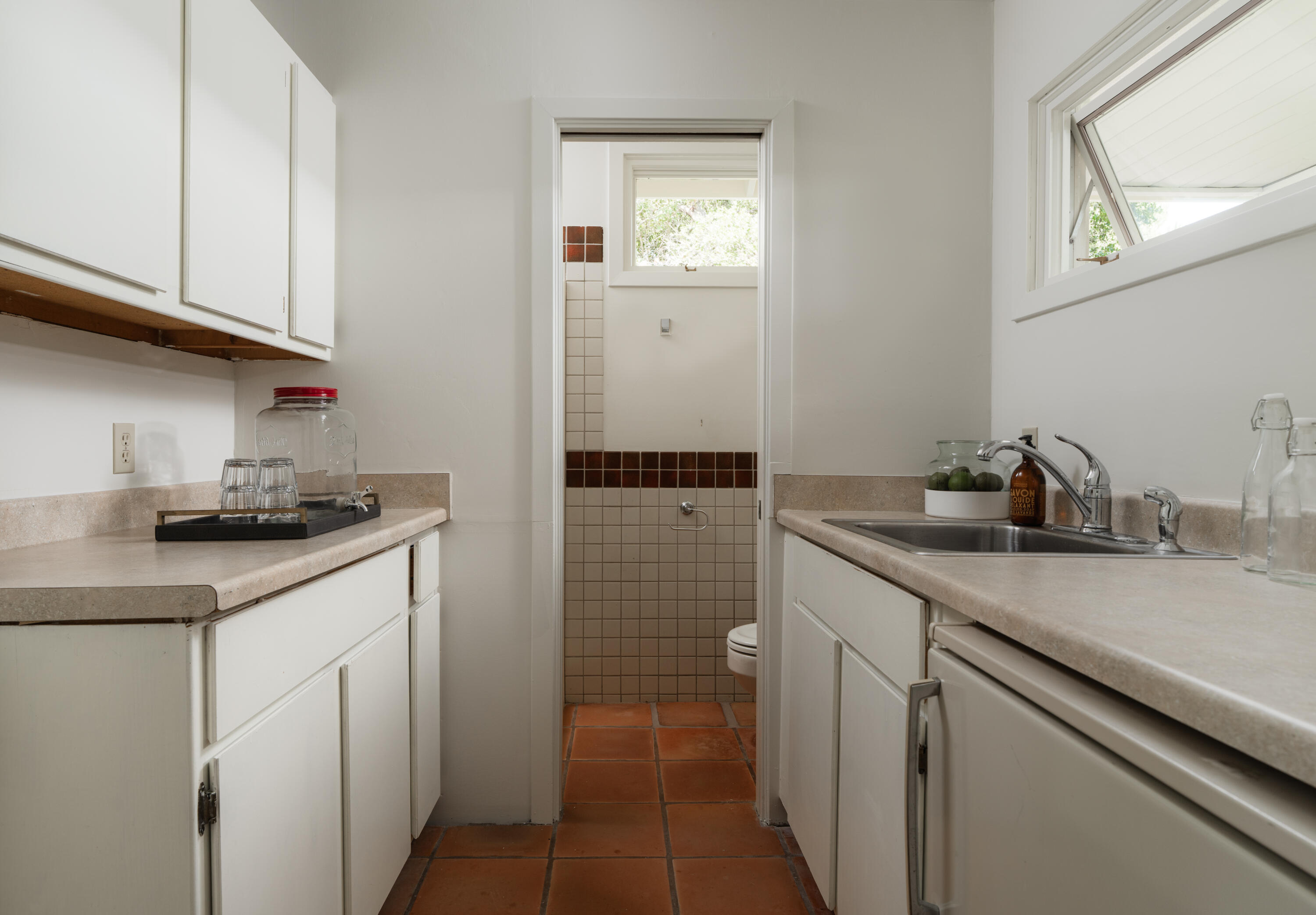 690 San Ysidro Road Montecito, CA 93108 - Photo 29 of 42 a kitchen with a sink and cabinets