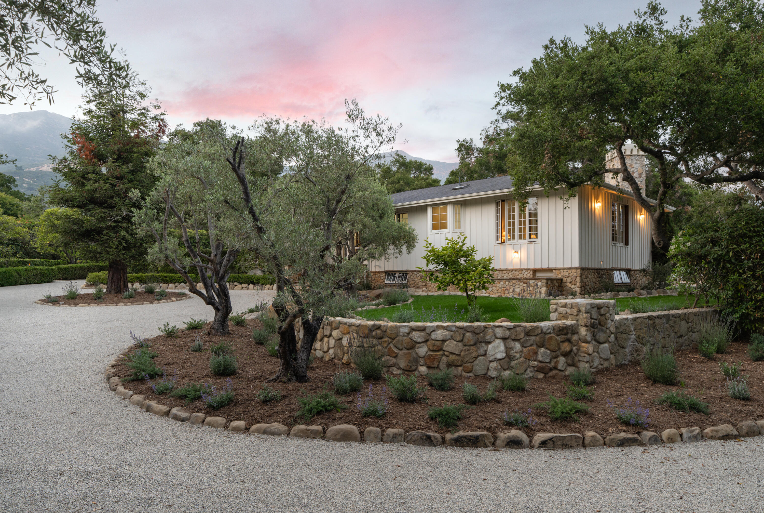 690 San Ysidro Road Montecito, CA 93108 - Photo 3 of 42 a view of a house with a yard and potted plants