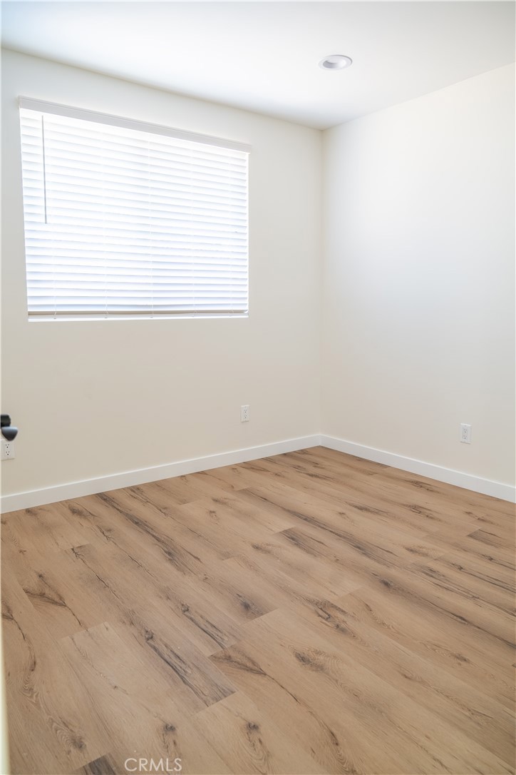 9350 Rhea Avenue Northridge, CA 91324 - Photo 13 of 20 an empty room with wooden floor and a window