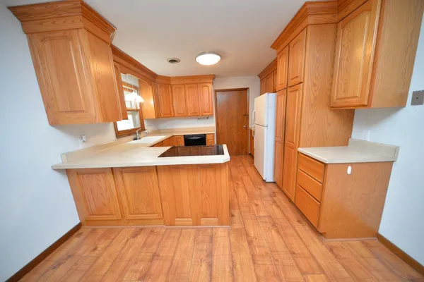 a kitchen with wooden cabinets and a sink