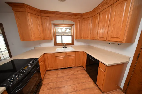 a kitchen with a sink stove and cabinets