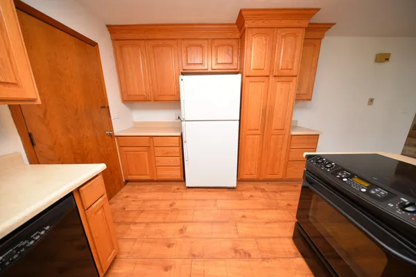 a kitchen with stainless steel appliances granite countertop a refrigerator and a stove