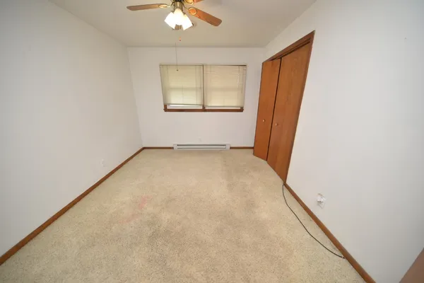 an empty room with windows and closet