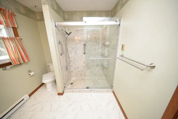 a bathroom with a glass shower door