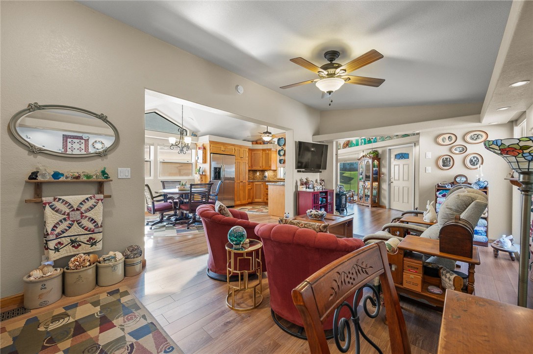 2000 Ramar Road, Unit 665 Bullhead City, AZ 86442 - Photo 13 of 83 Open-concept living space showcasing continuous luxury hard surface flooring, vaulted ceiling, and seamless flow to dining and kitchen.