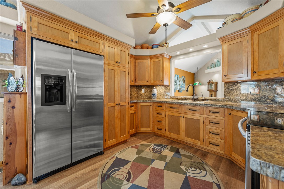 2000 Ramar Road, Unit 665 Bullhead City, AZ 86442 - Photo 17 of 83 Spacious kitchen with abundant cabinet and drawer storage, full-height pantry cabinetry, stainless steel refrigerator, and ceiling fan.