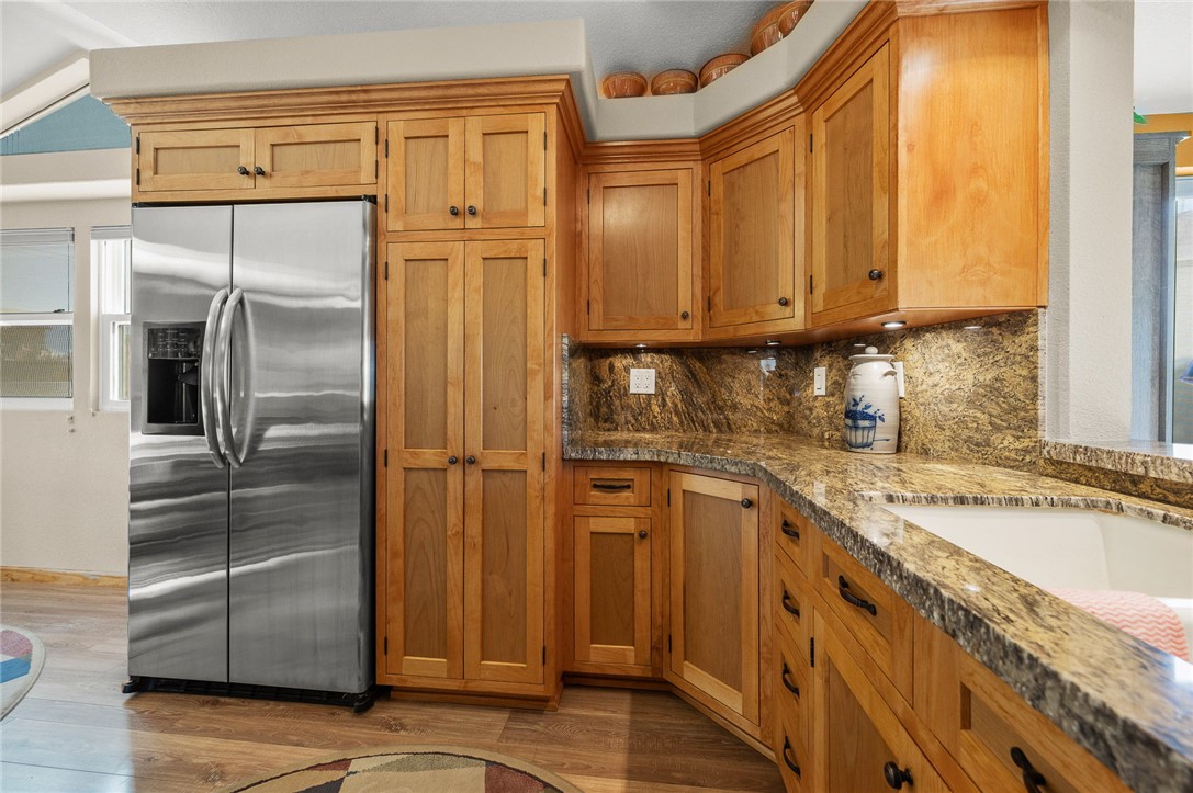 2000 Ramar Road, Unit 665 Bullhead City, AZ 86442 - Photo 18 of 83 Well-designed kitchen workspace showcasing granite counters, extensive lower cabinetry, corner storage, and quality wood finishes throughout.