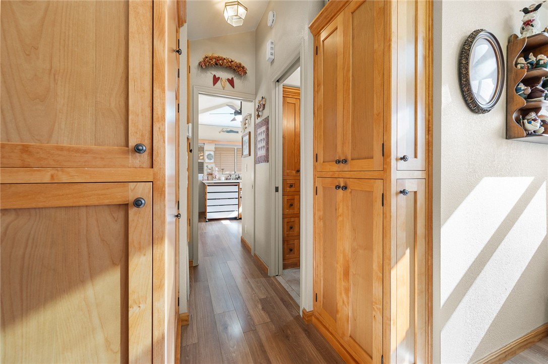 2000 Ramar Road, Unit 665 Bullhead City, AZ 86442 - Photo 22 of 83 Hallway featuring custom built-in cabinetry, luxury hard surface flooring, and excellent storage integrated throughout.