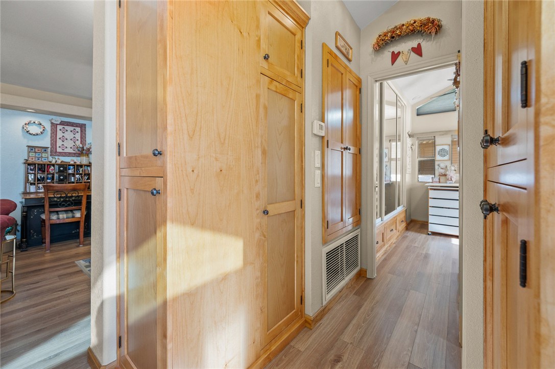 2000 Ramar Road, Unit 665 Bullhead City, AZ 86442 - Photo 23 of 83 Additional hallway storage with full-height custom cabinets, matching wood finishes, and convenient access to adjacent living spaces.