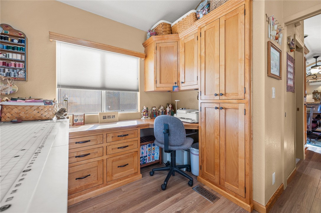 2000 Ramar Road, Unit 665 Bullhead City, AZ 86442 - Photo 26 of 83 Multi-use room featuring mirrored closet doors, built-in storage, and ample natural light; craft furnishings are not permanent, allowing reconfiguration as a bedroom or office.