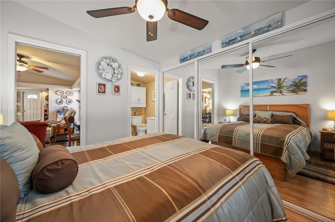 2000 Ramar Road, Unit 665 Bullhead City, AZ 86442 - Photo 31 of 83 Alternate view of primary bedroom showcasing mirrored closets, luxury hard surface flooring, and neutral wall tones.