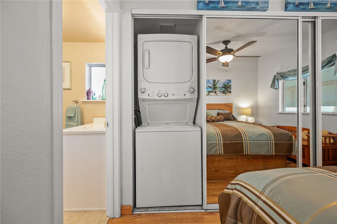 2000 Ramar Road, Unit 665 Bullhead City, AZ 86442 - Photo 32 of 83 In-room laundry area with stacked washer and dryer conveniently located in the primary closet in the primary bedroom, near bathroom.