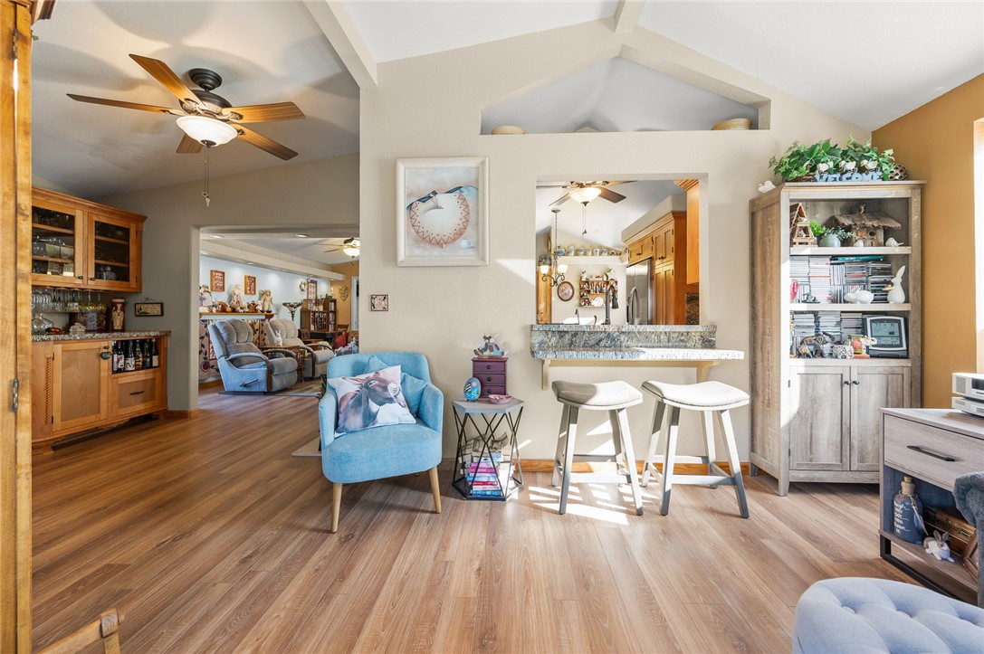 2000 Ramar Road, Unit 665 Bullhead City, AZ 86442 - Photo 39 of 83 Open living space with breakfast bar, granite counter, vaulted ceiling, and flexible seating arrangement.