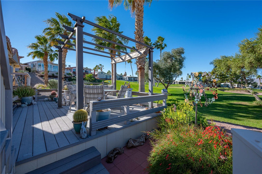 2000 Ramar Road, Unit 665 Bullhead City, AZ 86442 - Photo 43 of 83 Rear deck with pergola-style shade structure, composite decking, and direct golf course frontage