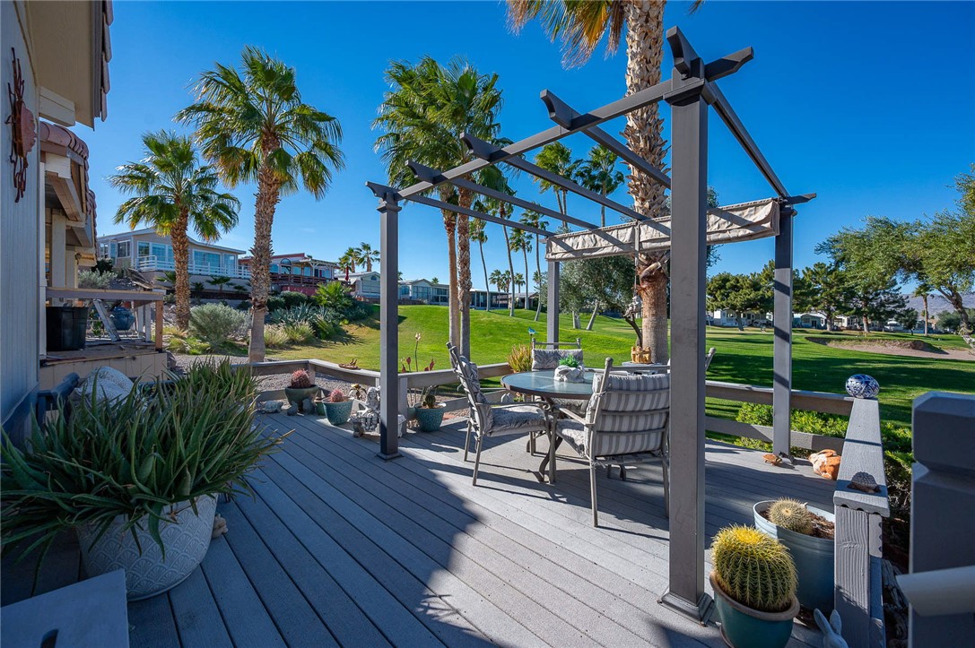 2000 Ramar Road, Unit 665 Bullhead City, AZ 86442 - Photo 44 of 83 Spacious outdoor entertaining area featuring elevated deck, pergola, and open views across the fairway.