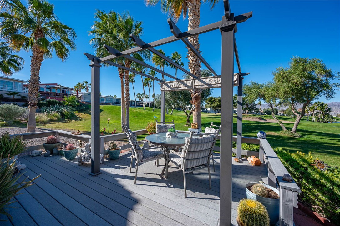 2000 Ramar Road, Unit 665 Bullhead City, AZ 86442 - Photo 45 of 83 Golf course?facing deck with ample room for outdoor dining, low-maintenance decking, and lush greenbelt views.