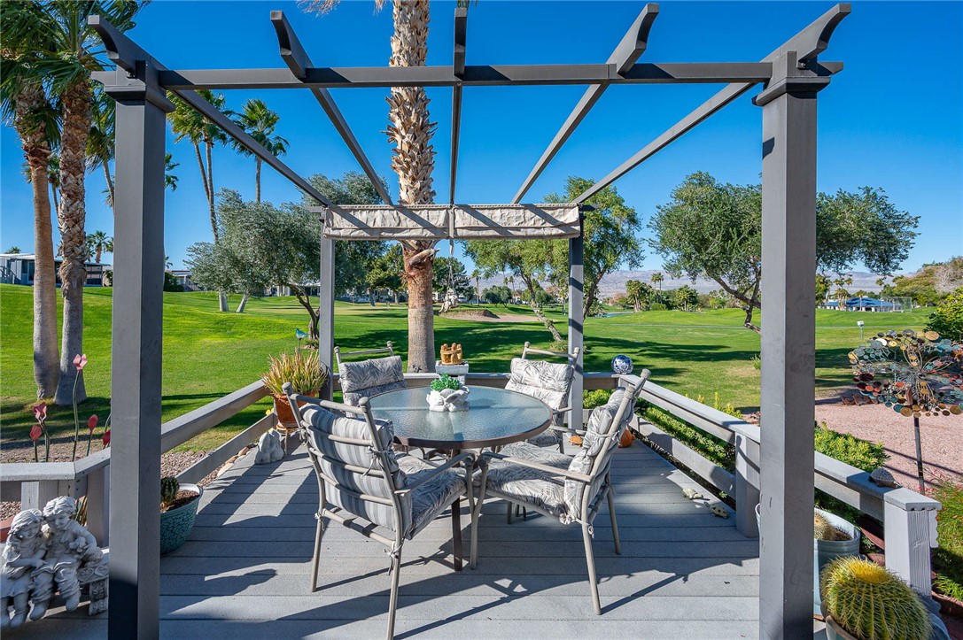 2000 Ramar Road, Unit 665 Bullhead City, AZ 86442 - Photo 47 of 83 Spacious outdoor entertaining area featuring elevated deck, pergola, and open views across the fairway.