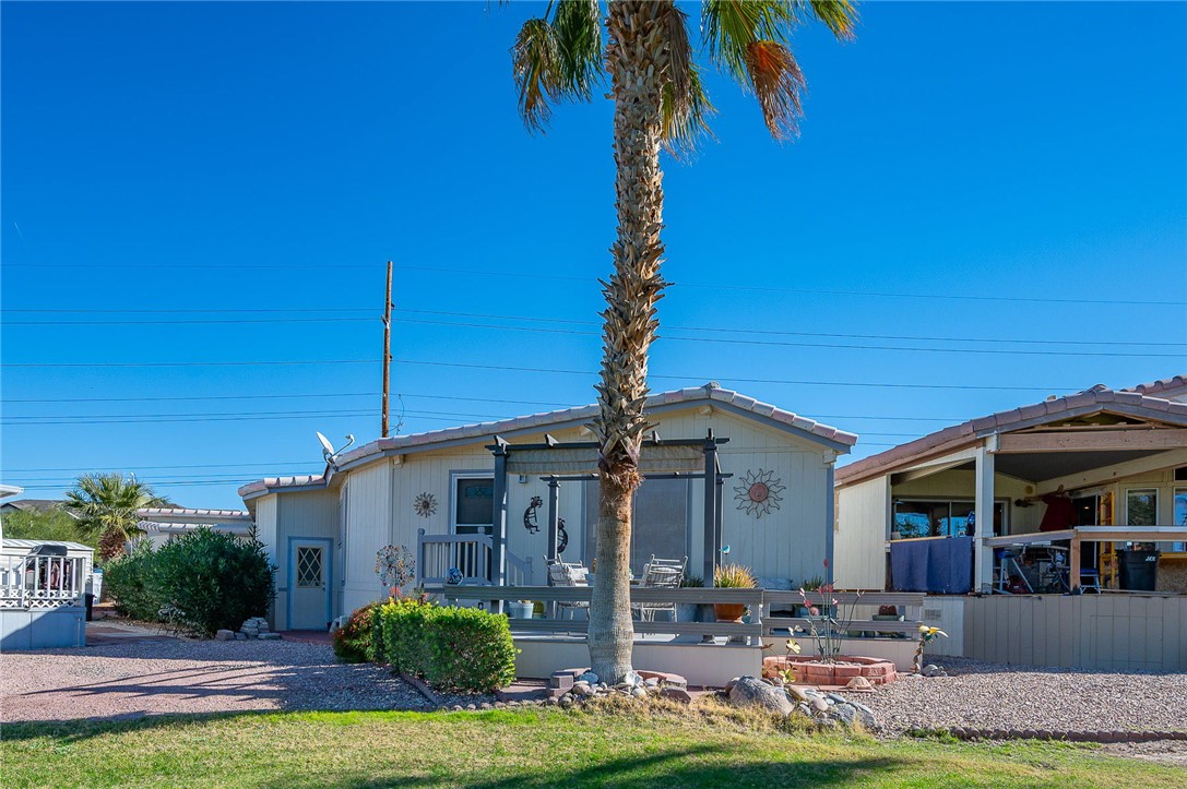 2000 Ramar Road, Unit 665 Bullhead City, AZ 86442 - Photo 50 of 83 Rear exterior view highlighting golf course frontage, raised deck, and pergola structure.