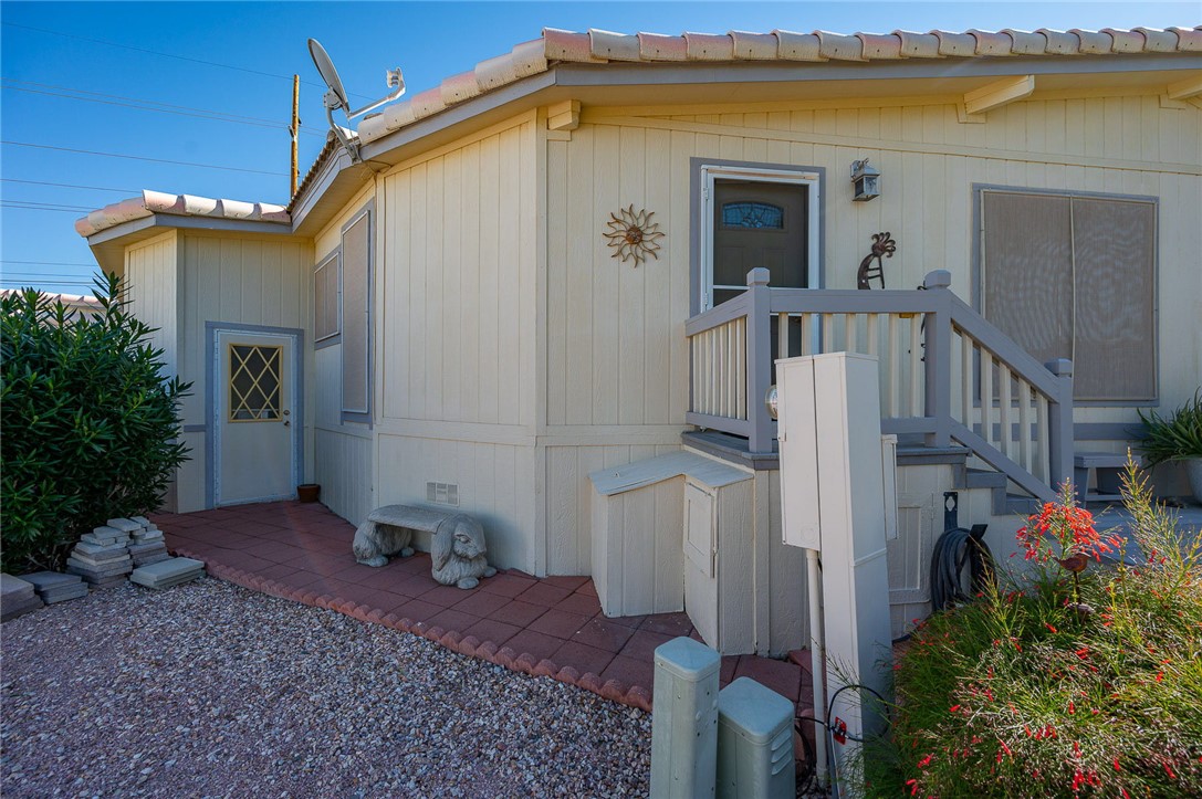 2000 Ramar Road, Unit 665 Bullhead City, AZ 86442 - Photo 52 of 83 Side yard access to storage shed, paver walkway, and easy exterior access along the side of the home.