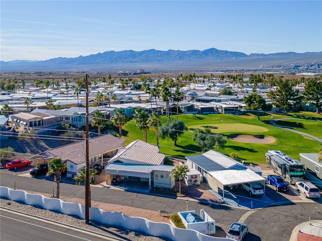 2000 Ramar Road, Unit 665 Bullhead City, AZ 86442 - Photo 56 of 83 Elevated neighborhood view showcasing golf course fairways, mature palms, and surrounding resort-style homes.