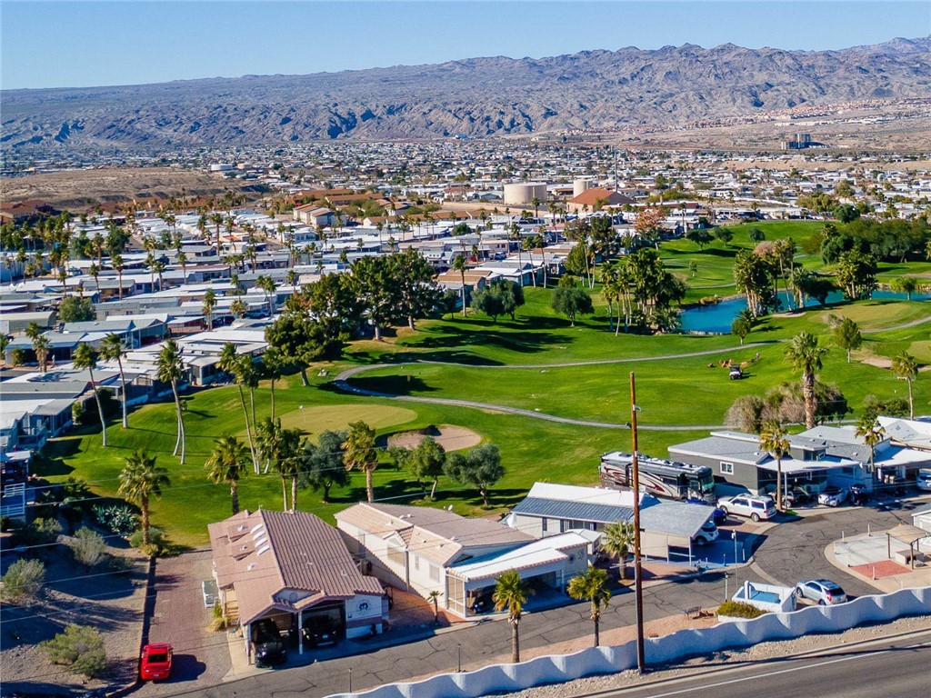 2000 Ramar Road, Unit 665 Bullhead City, AZ 86442 - Photo 58 of 83 Wide aerial view capturing the expansive golf course, water features, and scenic mountain backdrop.