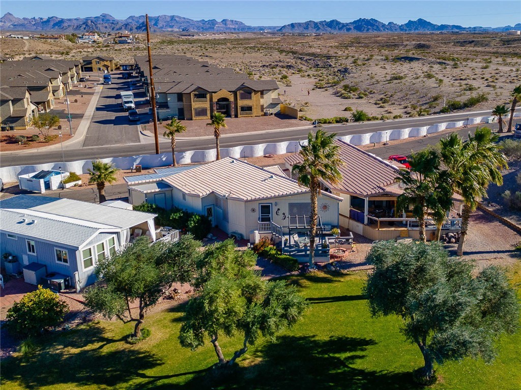 2000 Ramar Road, Unit 665 Bullhead City, AZ 86442 - Photo 59 of 83 Rear aerial perspective showing the home, deck, pergola, and fairway directly behind, highlighting a highly desirable lot placement.